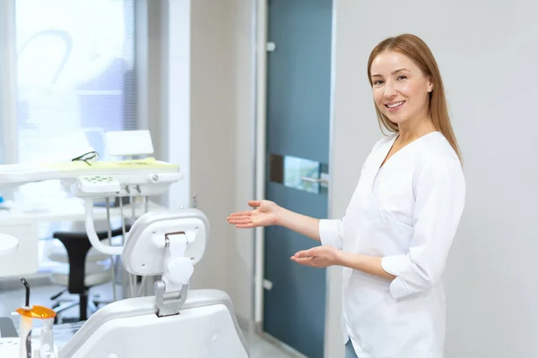 Portrait Smiling Dentist Standing Modern Clinic Office Inviting Sit Chair — 图库照片