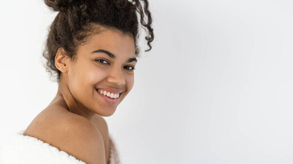 Web banner, portrait of happy young afro american woman smile wide, stand with naked shoulder in bathrobe, look at camera. Detox, botox, collagen, skincare and aesthetic medicine concept. Copy space