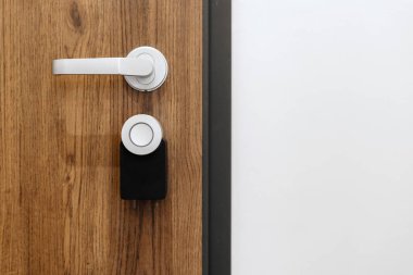 Digital smart lock security system with the password in office or hotel room. Close up view of front door with wireless connection and electronics keyless access. Unlock with online app