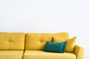 modern velvet couch with bright yellow color upholstery and cushions in living room for comfort rest and relax