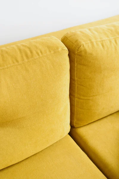 modern velvet couch with bright yellow color upholstery in living room for comfort rest and relax