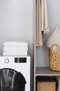 Cropped view of set of bathroom accessories and washing machine. Cleaning and laundry concept. Organizational space at home. Modern flat interior design
