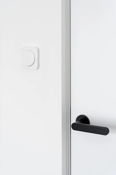 Cropped View Closed White Door Black Handle Light Switches Modern — Fotografia de Stock