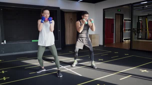 Boxing Trainer Weighted Punches Asian Man Woman Shadowboxing Using Weights — ストック動画