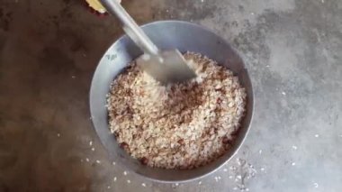 Pohaa and peanut frying in pan. In India, it is eaten with great fervor with tea in the evening. Its other names pauwa,sira,chira, oravalakki.Traditional snacks of India.
