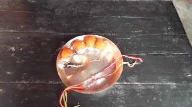 Puja plate decorated by a sister on the occasion of the festival of Raksha Bandhan.  Rakhi, lamp, and laddus are placed in a brass plate. A beautiful Pooja thali in India.