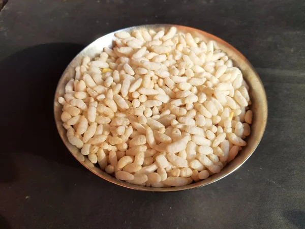 Puffed rice orpopped rice. Its puffed grainmade fromrice. A breakfast cerealsand other snack foods. Traditional methods to puff or pop rice frying inoil, sand and salt. Murmura, roasted grain.