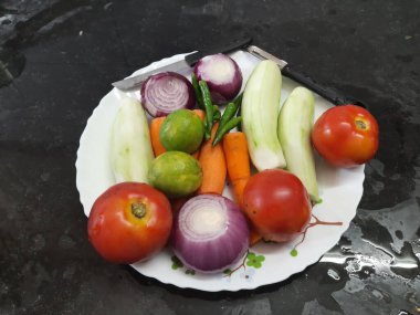 Sebze salata kesmeye hazır. Sebzeler yıkanır ve tabağa konur. Popüler salata sebzeleri soğan, salatalık, limon, havuç, domates ve yeşil biberdir..
