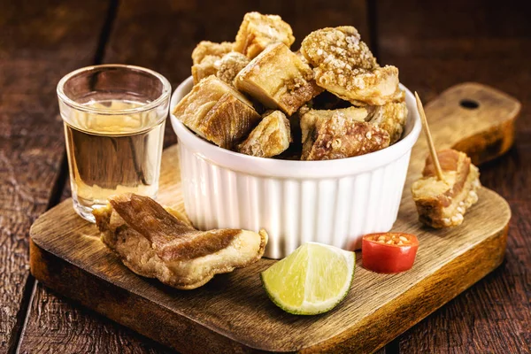 pork belly meat snack, crispy crackling typical of minas gerais, served with brazilian cachaca, bar food