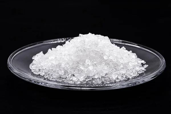 sodium chloride, known as salt or table salt, an important food preservative and a popular seasoning, isolated on black background