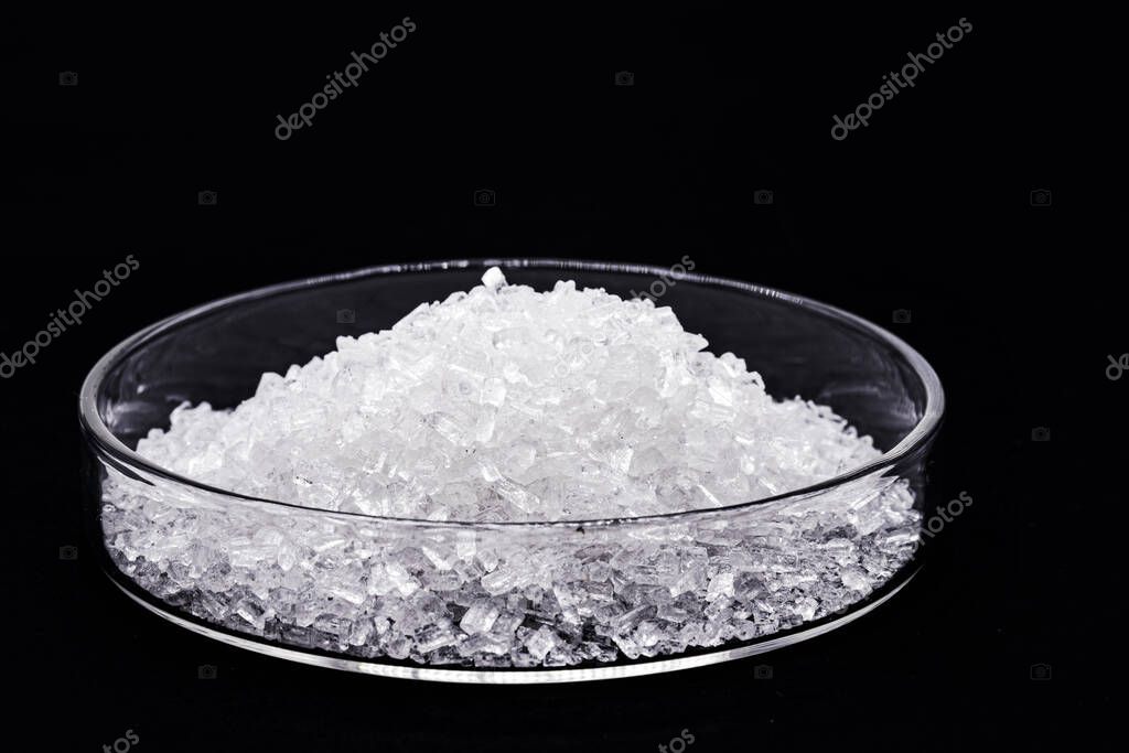 sodium chloride in petri dish, known as salt or table salt, important