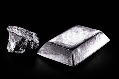 platinum ingot and nugget, noble metal, used in the production of catalysts, luxury jewelry, isolated black background