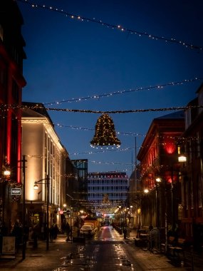 Reykjavik, Iceland - December 8, 2021: Bell-shaped Christmas illuminations in the street. Winter night, no people. 