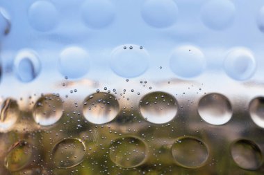 Circles and bubbles on blue and gray backgrounds. Abstract background for the design. Selective focus