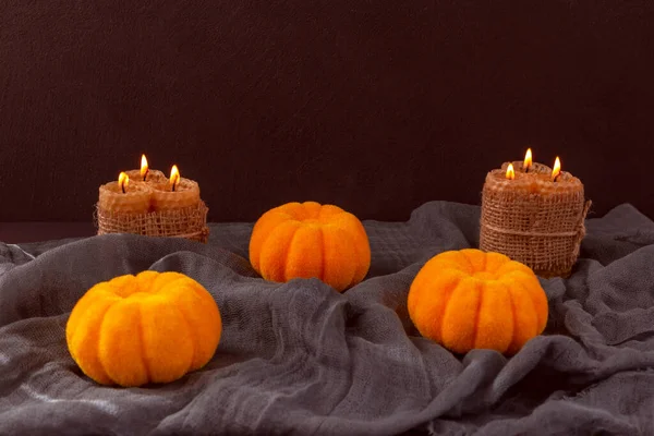Halloween Three Pumpkins Burning Candles Lie Dark Cloth Black Background — Stock Photo, Image