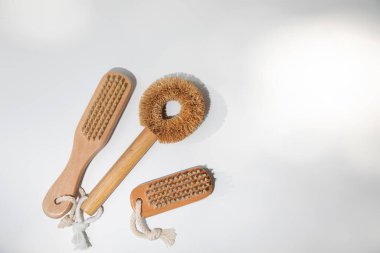 Eco brushes with wooden handles on a white background with shadows. Top view
