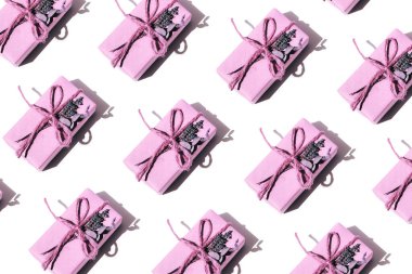Flat lay pattern of pink gifts in handmade packaging decorated with dry lavender and eucalyptus. Top view