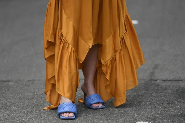 Street style outfit - woman wearing orange dress and purple open toe shoes
