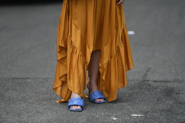 Street style outfit - woman wearing orange dress and purple open toe shoes