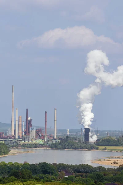 Intense smoke coming free while quenching cokes in a cokes factory next to a blast furnace, seen from the Halde Rheinpreussen near Duisburg