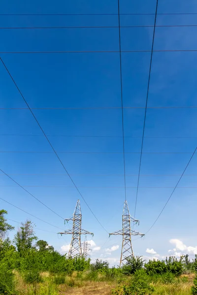 High voltage electrical lines and equipment against the blue sky.