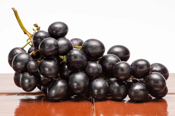 Czerwone Winogrona Izolowane Brązowym Kolorowym Kafelku — Zdjęcie stockowe