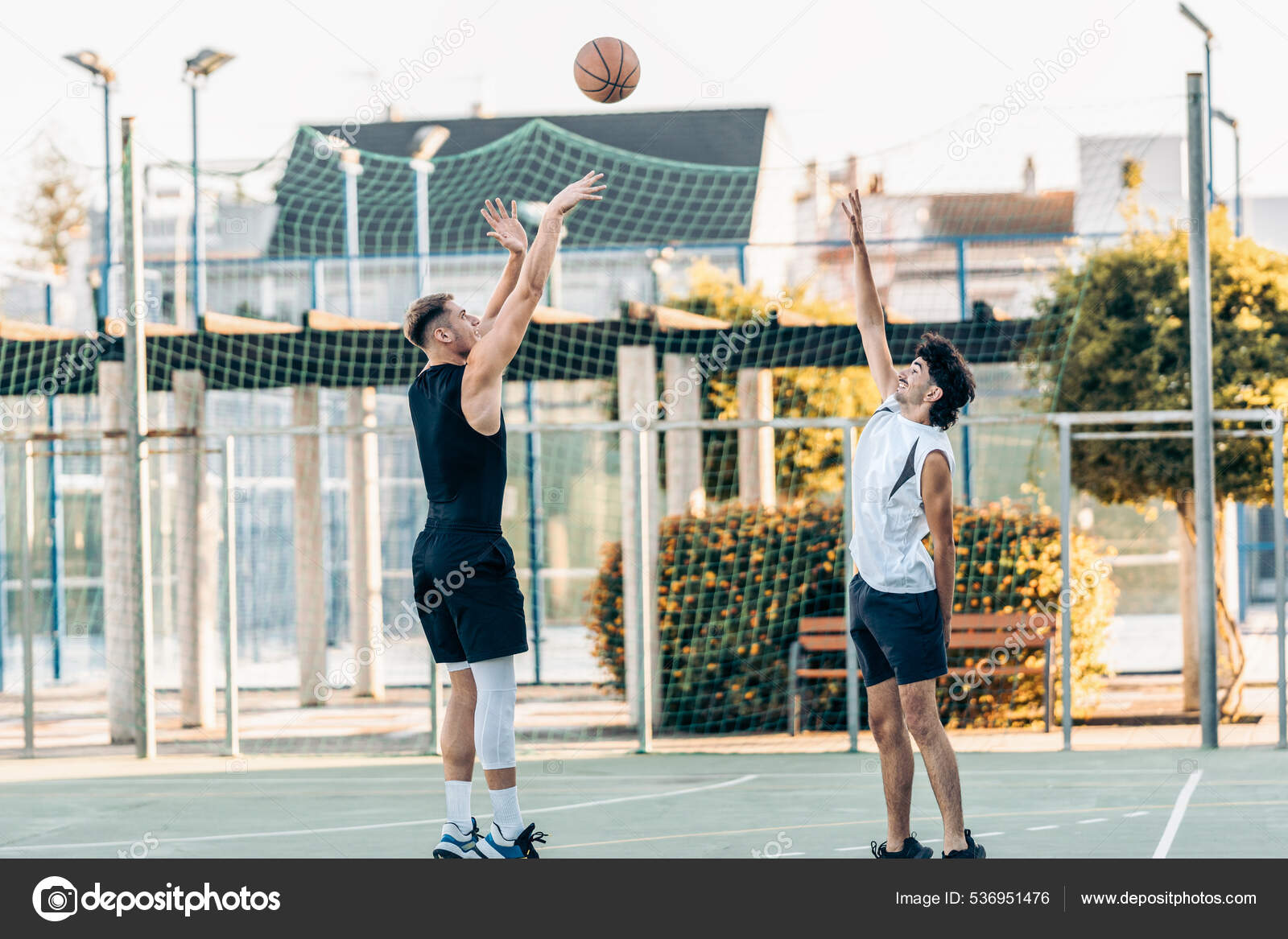Man shooting a three-pointer during a basketball match between friends outdoors Stock Photo by ©samuelperales 536951476