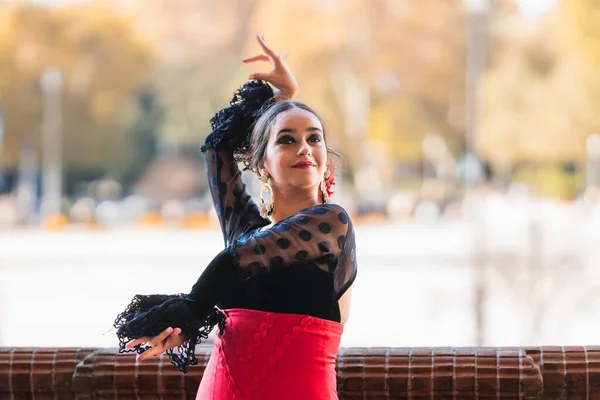 Woman dancing flamenco while raise the hands and wear a traditional dress — Zdjęcie stockowe