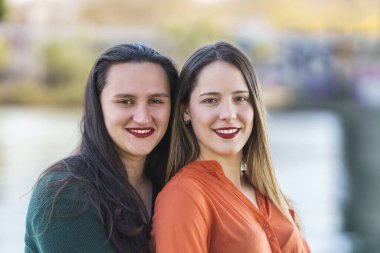 portrait of 2 lesbians embracing with great bokeh