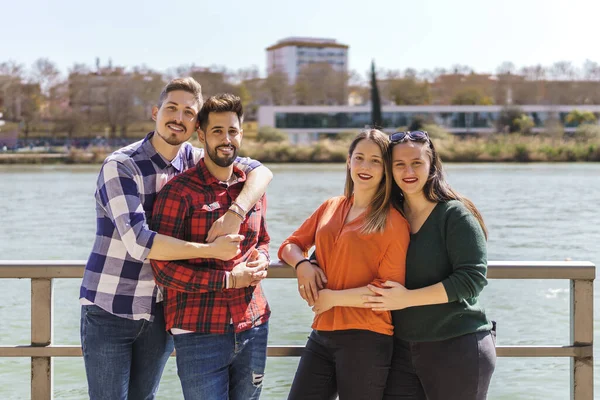 Portrait of lesbian couple and gay couple on floating jetty — Stockfoto