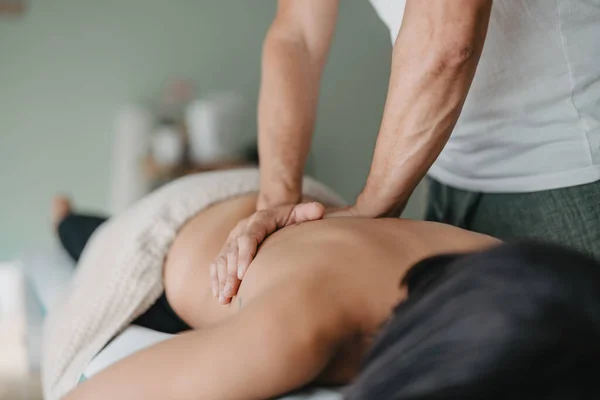 Woman Rests Stretcher While Physiotherapist Warms Her Muscles His Hands — Stockfoto