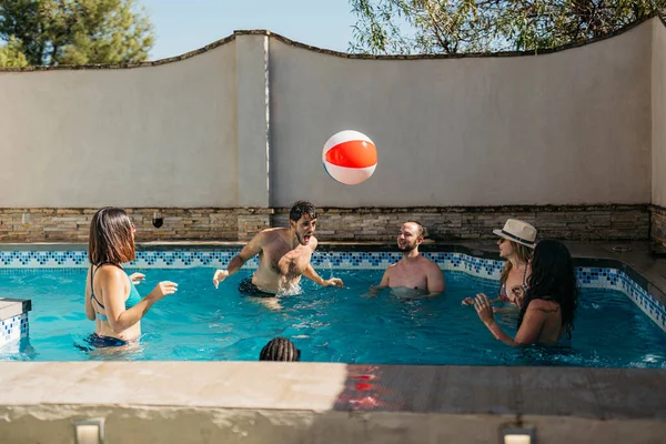 Man Hits Beach Ball His Head Swimming Pool Surrounded Friends — Stock Photo, Image