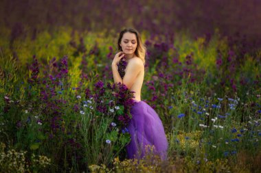 Çiçek tarlasında çıplak güzel bir kız.