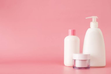 Cosmetics, Moisturizer, Bottle. Different cosmetic bottles. set of cosmetic products on pink background. Cosmetic package collection for cream, soups, foams, shampoo.