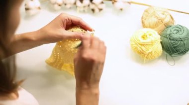 Womens hands knit with knitting needles from woolen, cotton threads. Hobbies and needlework from handmade yarn.