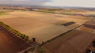 view from a height from a drone to the fields, the village and the gloomy sky in autumn.