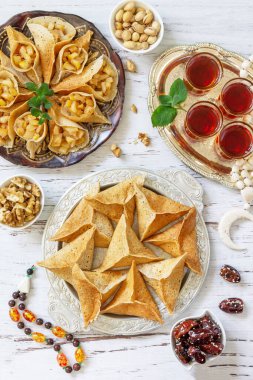 Ramazan kareem bayramı, oruç, helal yiyecekler. Ramazan menüsü: Türlü Arap krep katayef ve hurma, şam fıstığı. Üst görünüm düzlüğü.