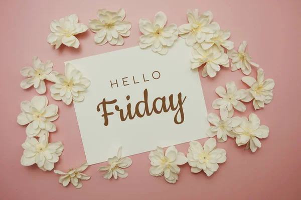 Hello Friday card typography text with flower bouquet on pink background