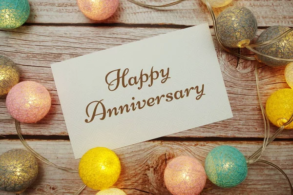 Happy Anniversary Card Typography Text Led Cotton Ball Wooden Background — Fotografia de Stock