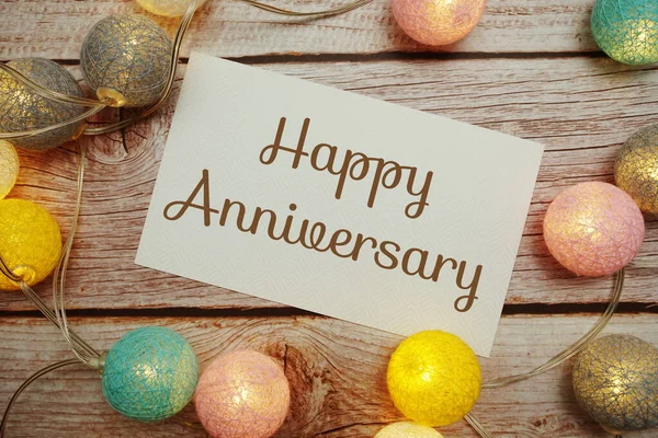 Happy Anniversary Card Typography Text Led Cotton Ball Wooden Background — Fotografia de Stock