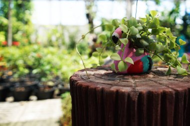 Çalar saat ve ev modeli yeşil arka planlı masada.