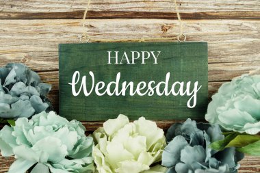 Ahşap arka planda mavi çiçek buketi olan mutlu Çarşamba yazı metinleri