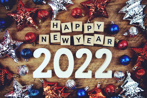 Happy New Year 2022 alphabet letters with Christmasl Decoration on wooden background