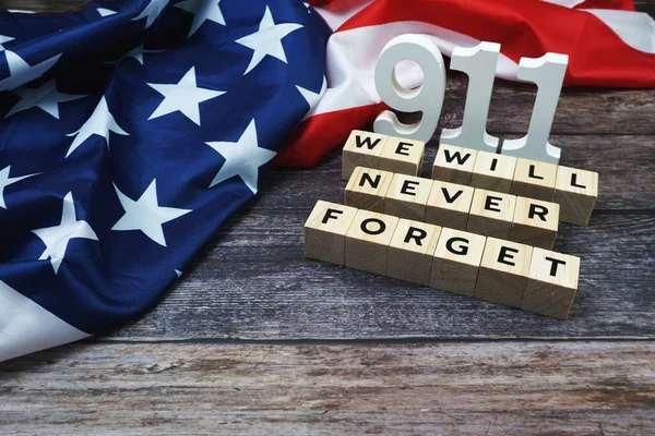 911 We will Never Forget alphabet letters with USA Flag on wooden background