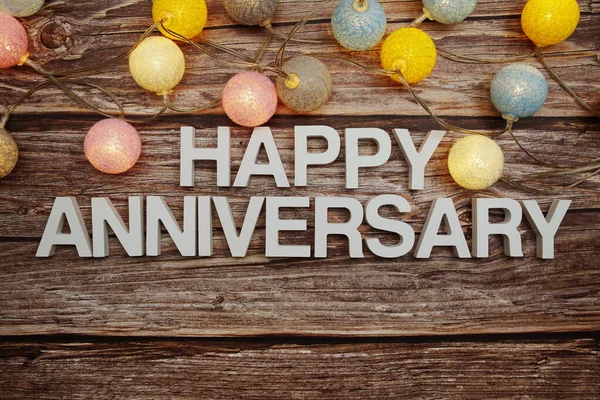 Happy Anniversary Text Led Cotton Balls Decoration Wooden Background — Stock Photo, Image