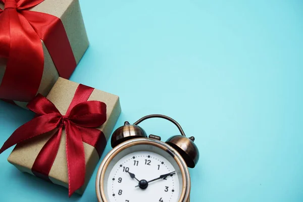 Gift Boxes Red Ribbon Alarm Clock Blue Background Royalty Free Stock Images