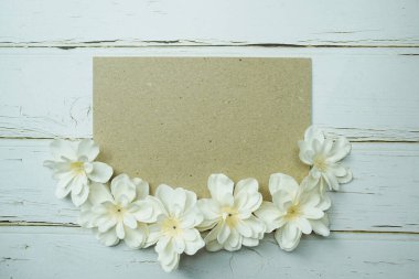 Empty paper craft with flower bouquet Top view on wooden background
