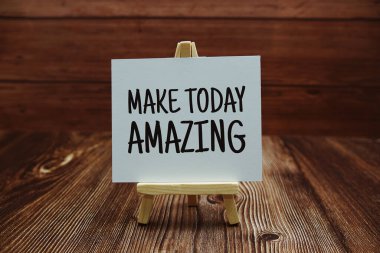 Make Today Amazing text on paper card on wooden background