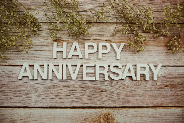 Happy Anniversary Alphabet Letters Flowers Frame Wooden Background — Fotografia de Stock