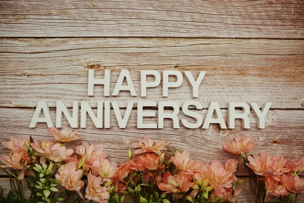 Happy Anniversary Alphabet Letters Flowers Frame Wooden Background — Stok fotoğraf